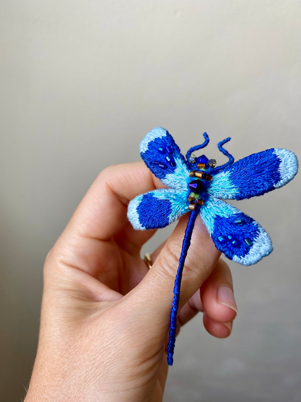 Hand-embroidered deep blue dragonfly brooch with glass beads, handmade in Vienna