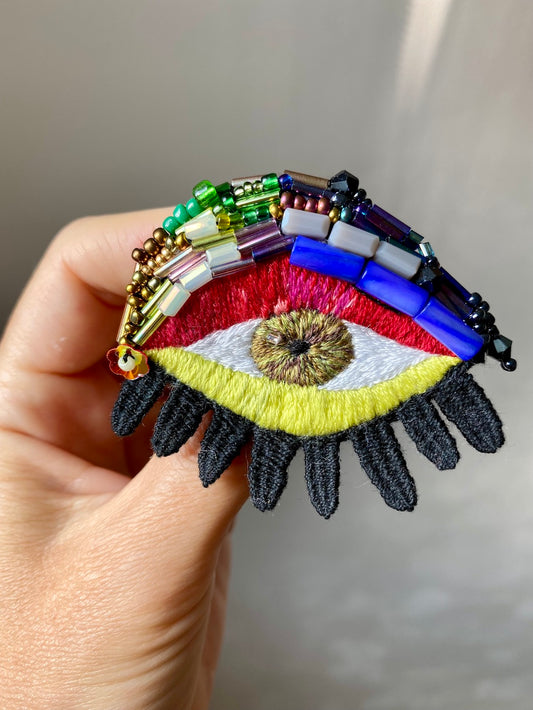 Hand-embroidered rainbow eye brooch with glass beads, handmade in Vienna, Austria