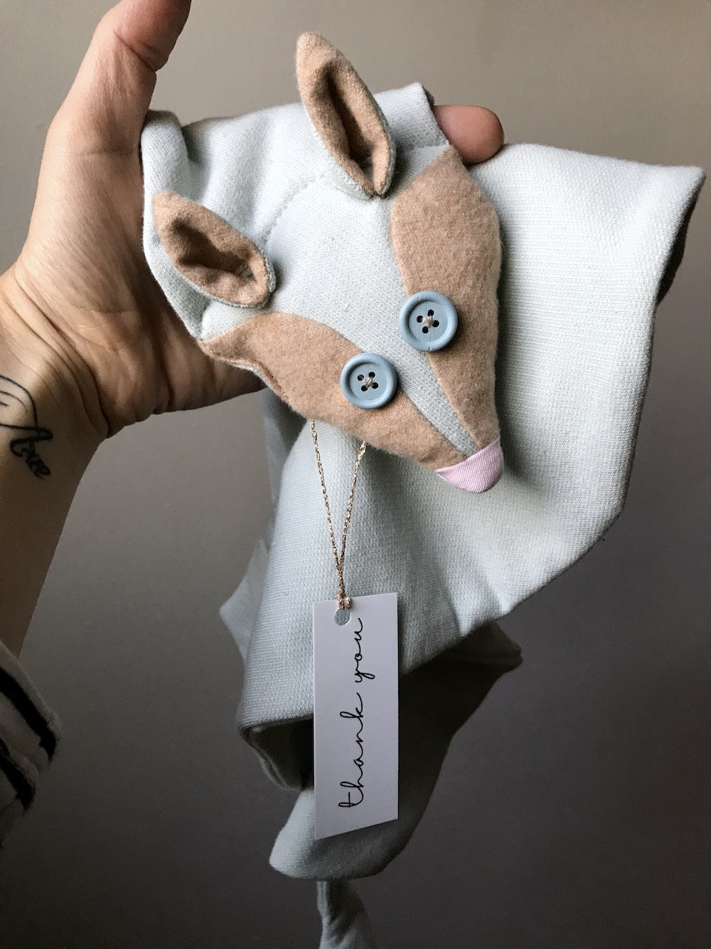 Light blue organic cotton fox scarf for kids with wooden eyes, made from soft fabric for a cozy fit.