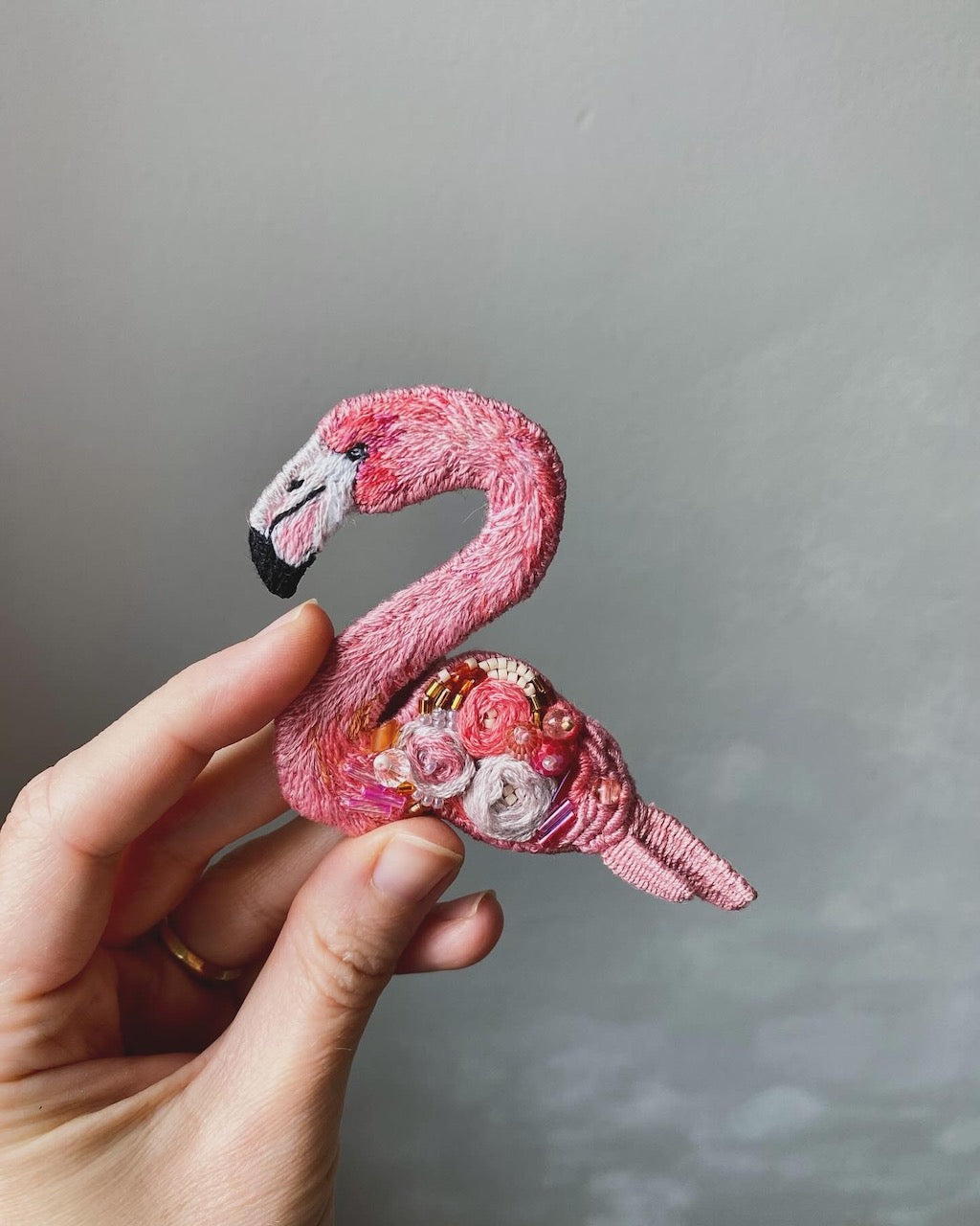 Pink flamingo brooch, hand-embroidered with fine glass beads on fabric.