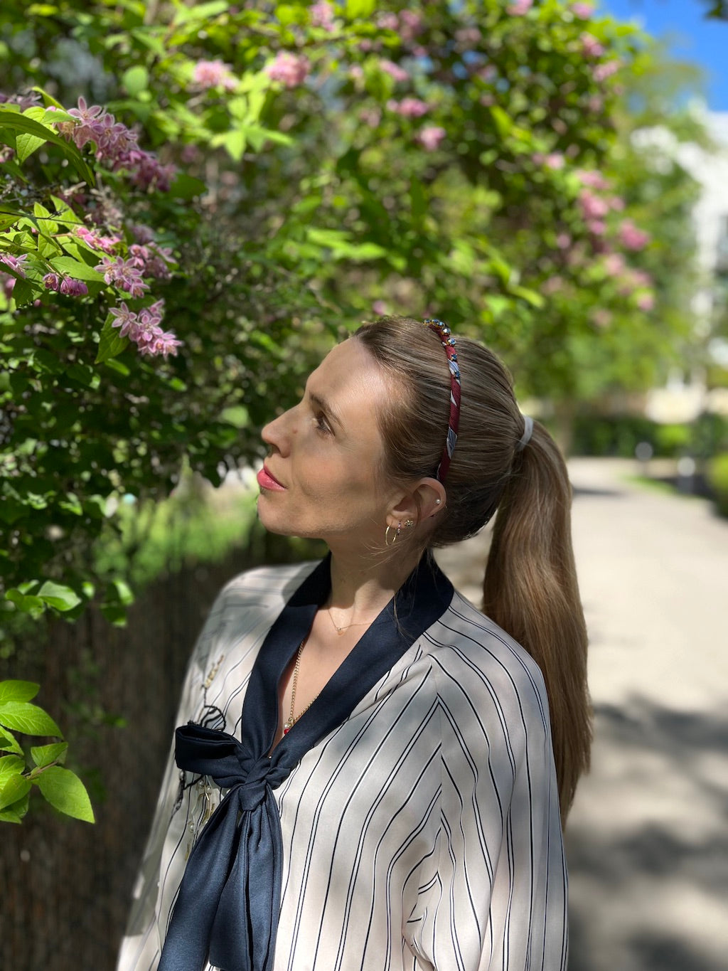 Silk Tie Headband in Burgundy worn on model outdoors