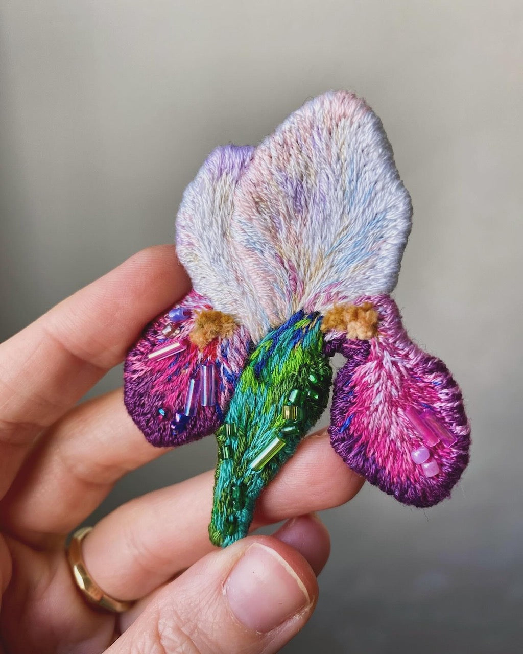 Hand-embroidered white iris flower brooch with glass beads, handmade in Vienna