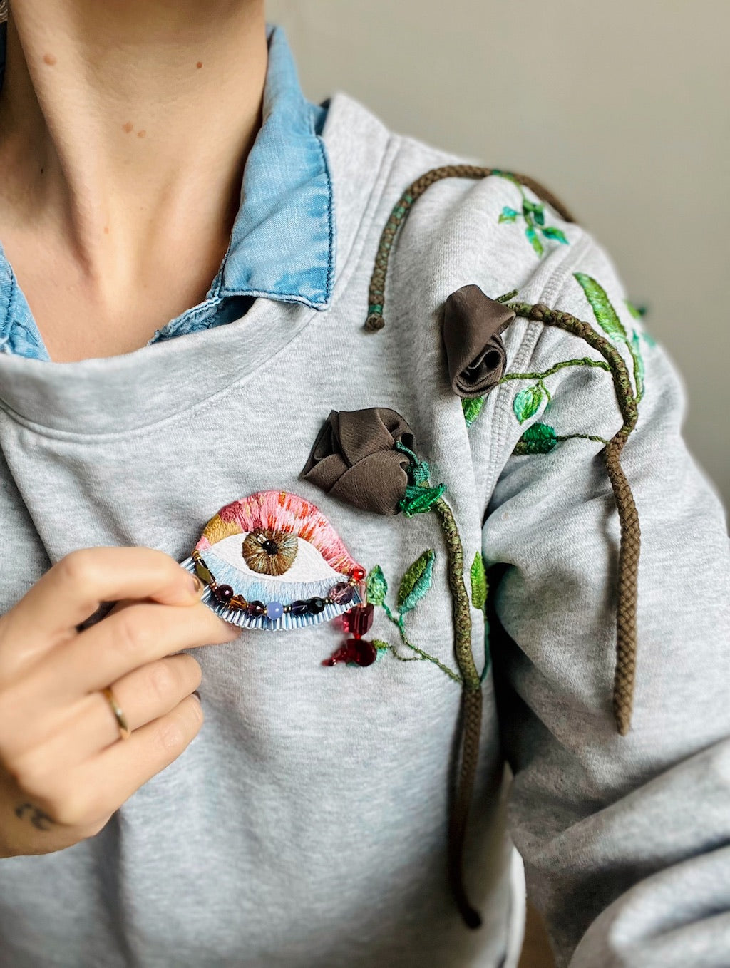 Hand-embroidered statement eye brooch with multicolor glass beads, handmade in Vienna